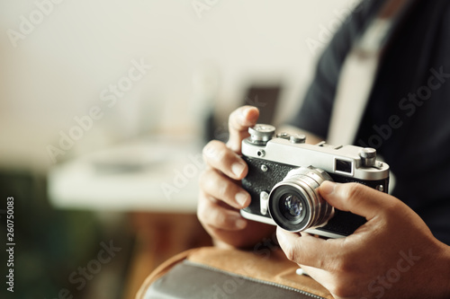 Photographer hands holding vintage camera