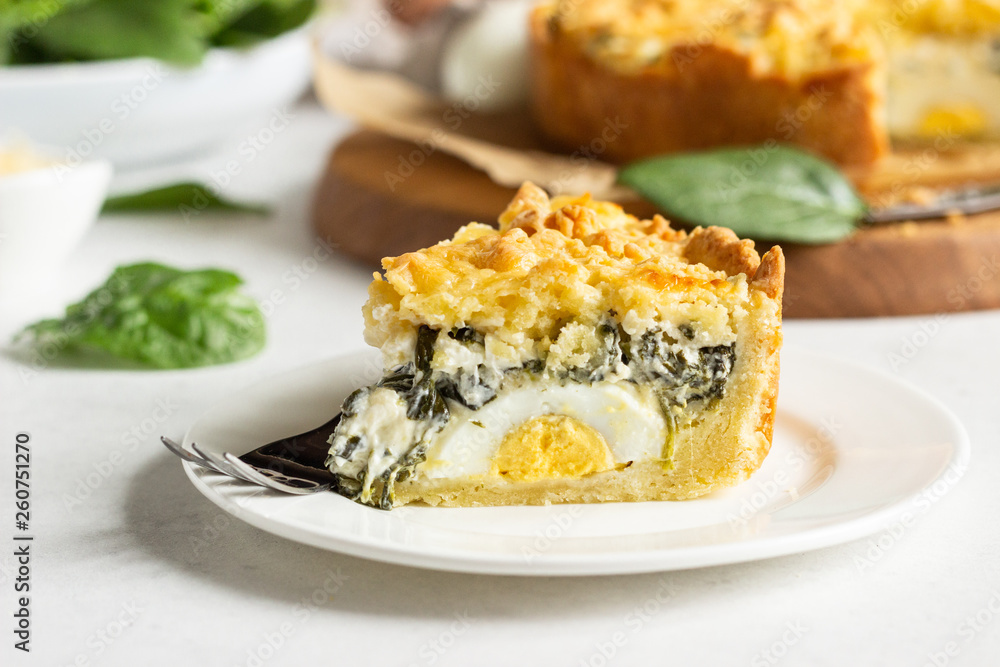 Tart or pie with spinach, ricotta and eggs. Torta Pascualina, typical Italian Easter food. Light grey background. Copy space. Tart or pie with spinach, ricotta and eggs. Torta Pascualina, typical Italian Easter food. Light grey background. Copy space.