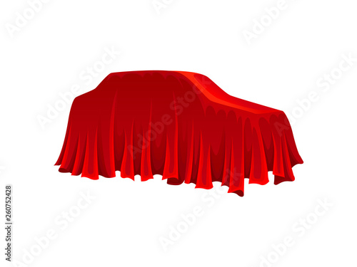 Car under red silk cloth on white background.