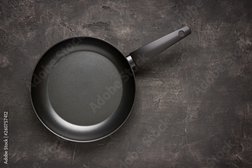 Empty Frying Pan Black on Dark Stone Surface. Culinary Background.