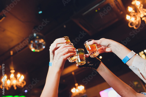 Hand holding a glass shot with vodka shot. photo