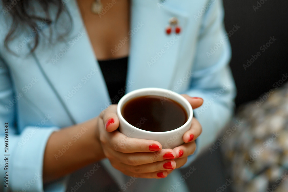 top view woman in blue jacket hold cup of coffee