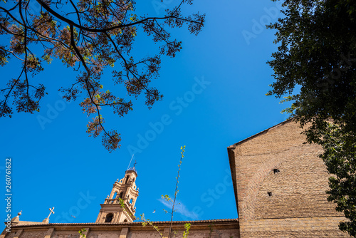 Side wall of the church of La Fonteta, in Valencia, with its bell tower illuminated by the sun. photo