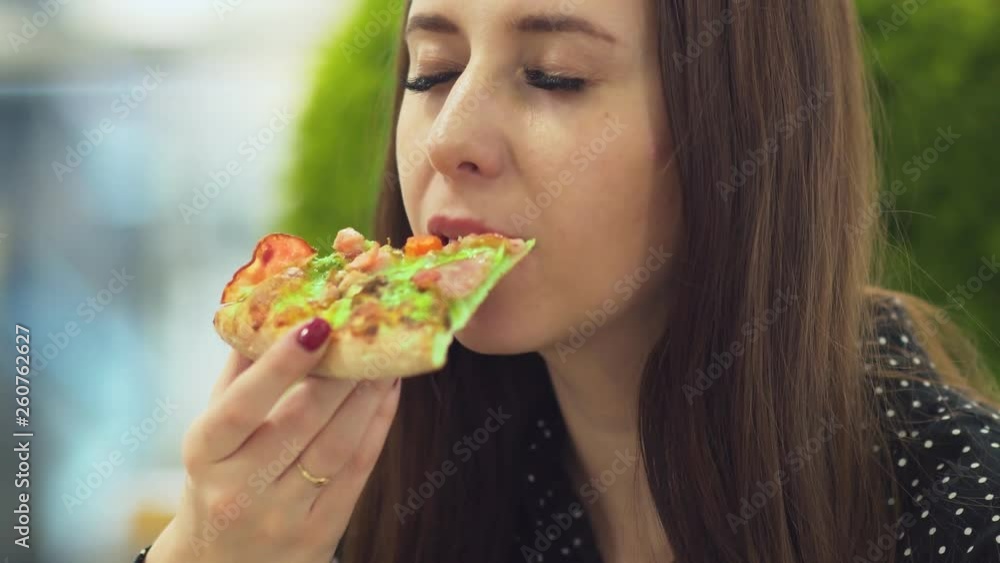 Young woman in cafe enjoying delicious pizza Young woman in cafe enjoying delicious pizza