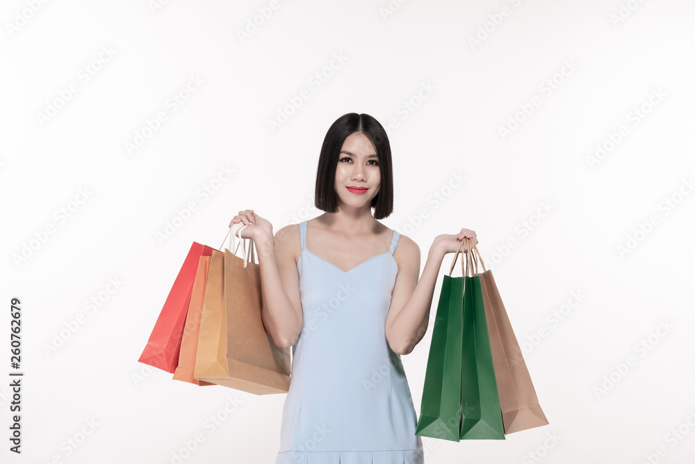 Shopping concept. Beautiful girl is carrying a bag on a white background. Asian girls are buying things happily. Shopping concept. Beautiful girl is carrying a bag on a white background. Asian girls are buying things happily.