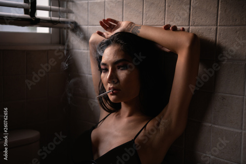 Sexy concept. Sensual women are sucking cigarettes in the toilet. Sexy women are relaxed by sucking cigarettes.