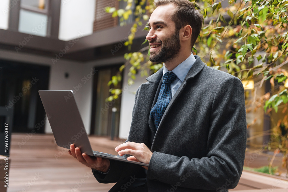 Attractive young businessman wearing suit walking Attractive young businessman wearing suit walking