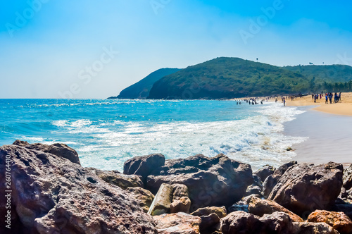 Yarada Beach, Visakhapatnam, India 10 December 2018 - People relaxing and enjoying in Yarada Beach. The Coast area is surrounded by hills and Bay of Bengal with lush green trees and golden soft sands.