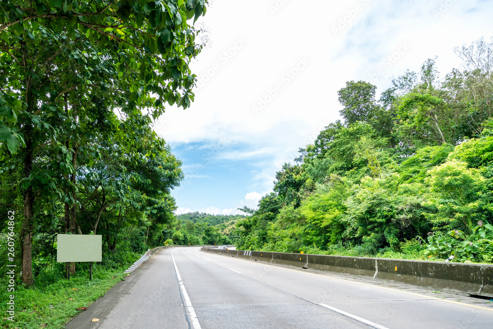 Beauty empty highway road with lamp post and tree on cloudy and blue sky day background Beauty empty highway road with lamp post and tree on cloudy and blue sky day background