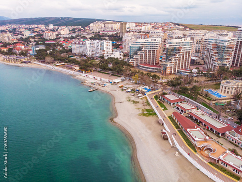 Aerial view of new modern buildings at sea coastline near sand beach, Gelendzhik city - resort on black sea for summer tourism and vacation