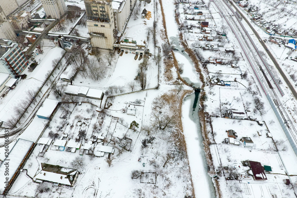 Sprinkled with snow grain elevator. Winter view of the old Soviet elevator. Winter view from the bird's eye view of the village. The streets are covered with snow Sprinkled with snow grain elevator. Winter view of the old Soviet elevator. Winter view from the bird's eye view of the village. The streets are covered with snow