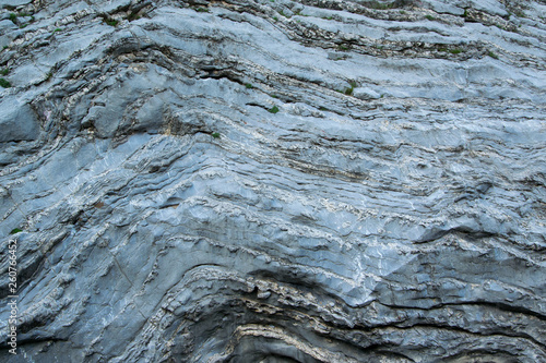 Close up view of natural wavy rochy formation. Abstract rough design photo