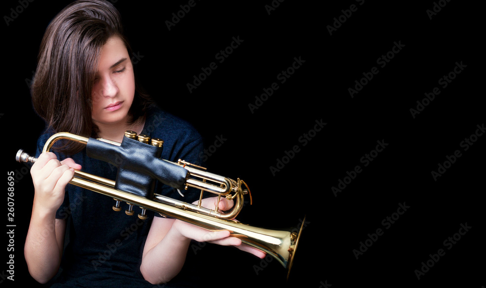 Obraz premium Portrait of a teenager with trumpet in studio.