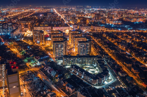 Aerial panoramic view, flight on drone above night city Voronezh with illuminated roads and high-rise buildings