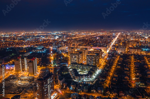 Aerial panoramic view, flight on drone above night city Voronezh with illuminated roads and high-rise buildings © DedMityay