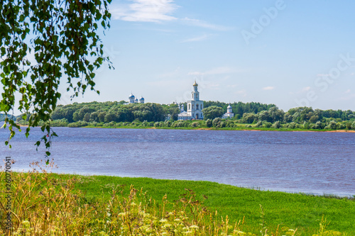 View to Volkhov river and St. George's or Yuriev Monastery in sunny day. Picturesque summer landscape and architectural landmark. UNESCO world heritage site. Velikiy Novgorod, Russia