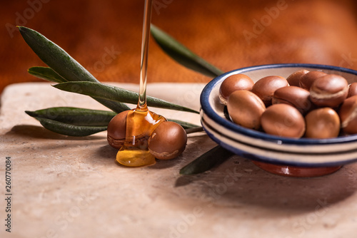 argan oil pouring over argan seeds