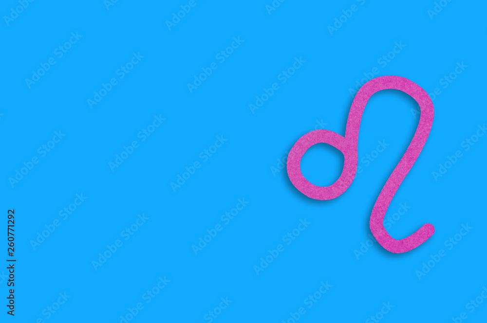 Symbol of astrological sign leo cut out of purple paper on blue table. Top view. Horoscope concept. Copy space for your text Symbol of astrological sign leo cut out of purple paper on blue table. Top view. Horoscope concept. Copy space for your text