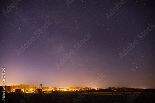 Milky Way over the illuminated small village
