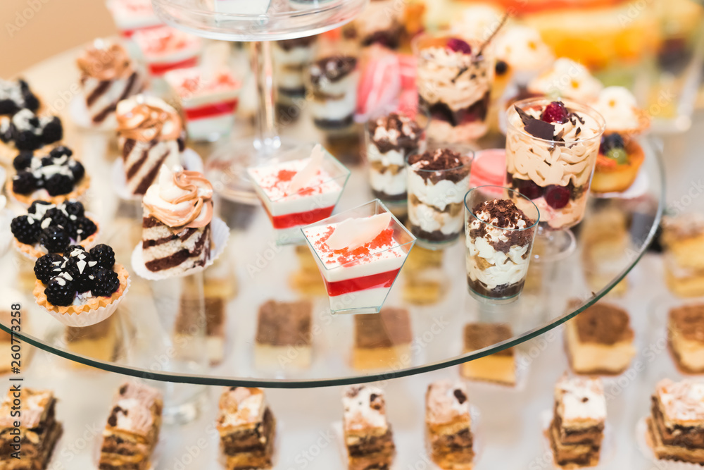 Delicious sweets on wedding candy buffet with desserts, cupcakes Delicious sweets on wedding candy buffet with desserts, cupcakes