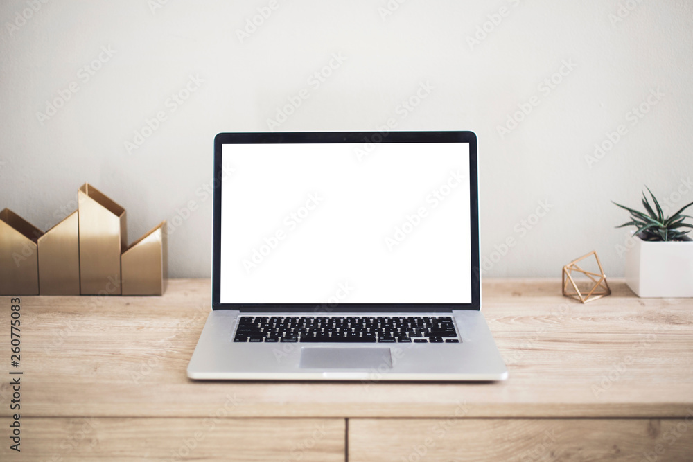 Mock up of a laptop computer with white blank screen on wooden work ...