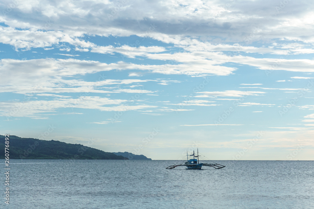 Obraz premium Classic Philippine fishing boat on the background of the sea landscape.