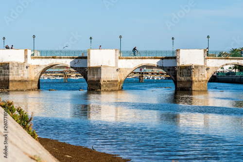 Old roman bridge over Gilao river in Tavira, Algarve, Portugal