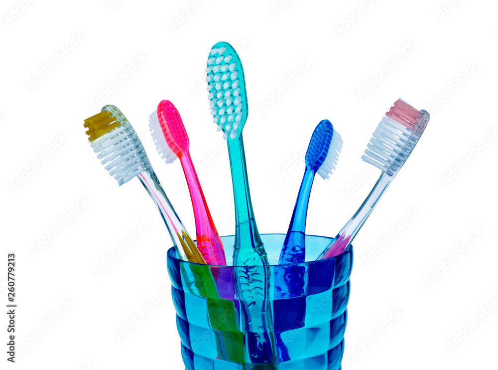 Toothbrushes in a glass isolated on white Toothbrushes in a glass isolated on white