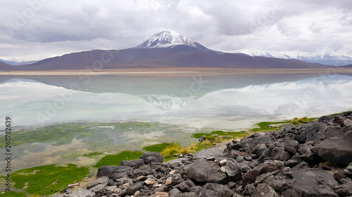 View of the Laguna Blanca in the desert landscape of the Andean highlands of Bolivia with the peaks of the snow-capped volcanoes of the Andes