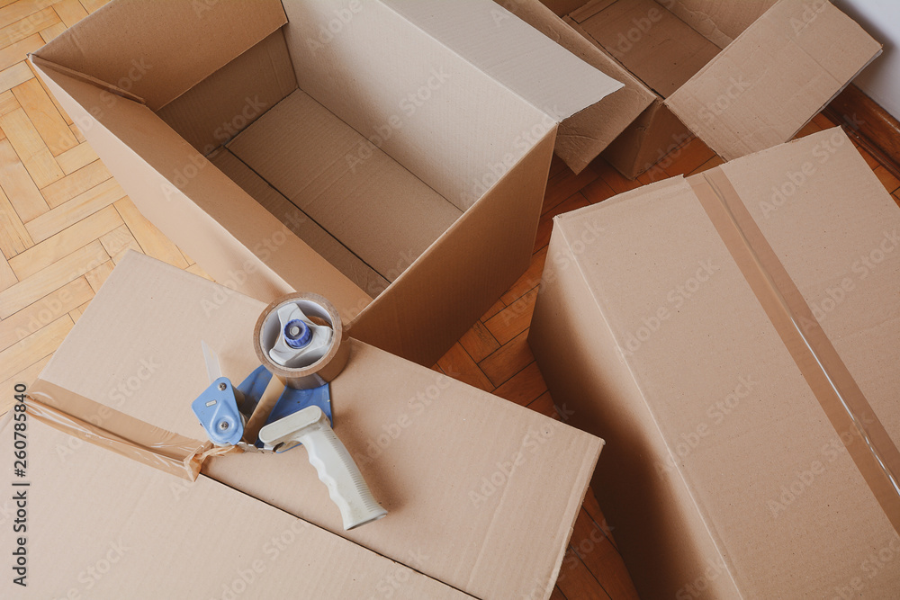 © Mego-studio - Tape dispenser sealing a shipping cardboard box © Mego-studio - Tape dispenser sealing a shipping cardboard box