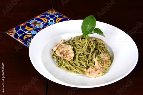spaghetti dish with pesto sauce and chicken 