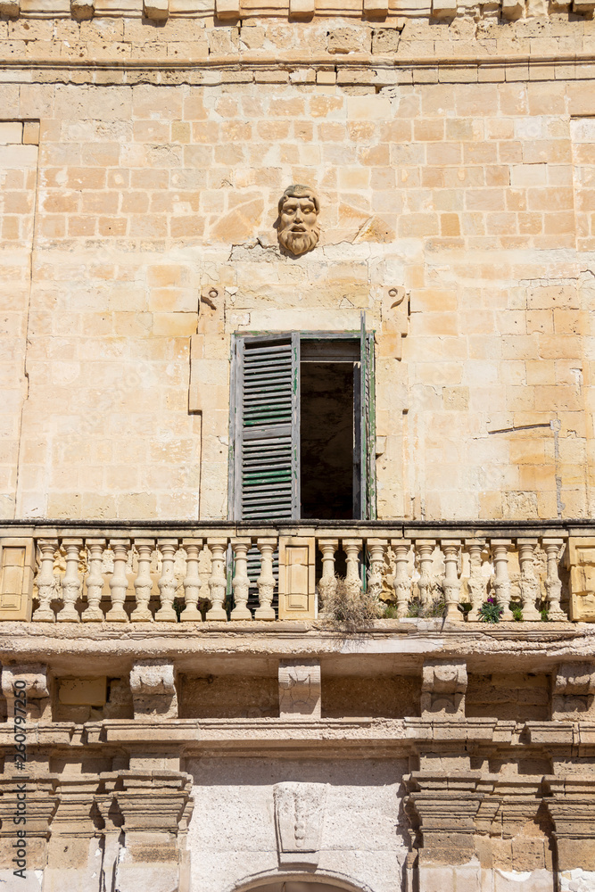 Beautiful facade detail of an old abandoned building in Birgu, Malta