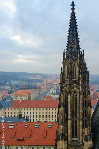 Gothic stone tower of St. Vitus Cathedral on background of city, Prague, Czech Republic