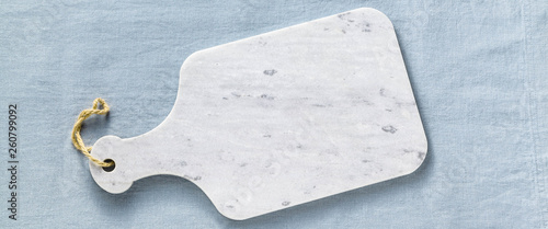 Photography marble cutting board obanner of marble cutting board on a blue linen tablecloth