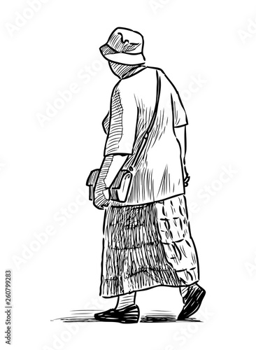 A casual old woman goes down the street