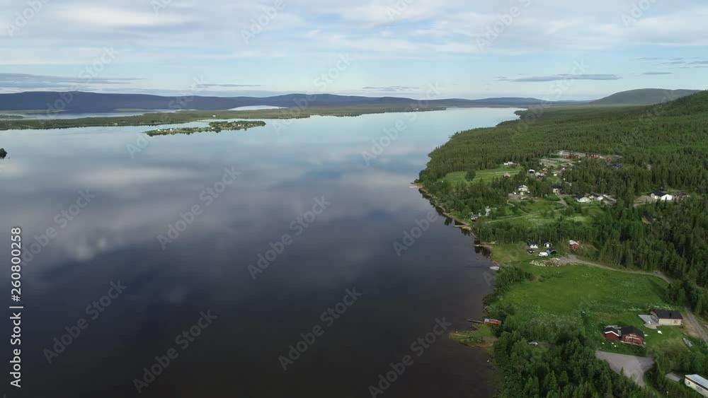 Aerial view of idyllic landscape with lake and forest at sunset. Flying over huge lake in North Sweden. Aerial view of idyllic landscape with lake and forest at sunset. Flying over huge lake in North Sweden.