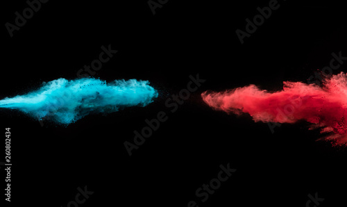 Super slow motion of flying coloured powder on black background