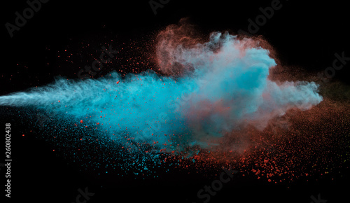 Collision of two colored powders isolated on black