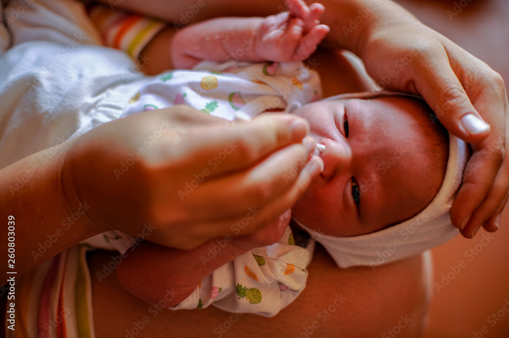newly born baby. The first days of life. Happy baby and mom at home. Feeding, wiping, hygienic procedures. newly born baby. The first days of life. Happy baby and mom at home. Feeding, wiping, hygienic procedures.