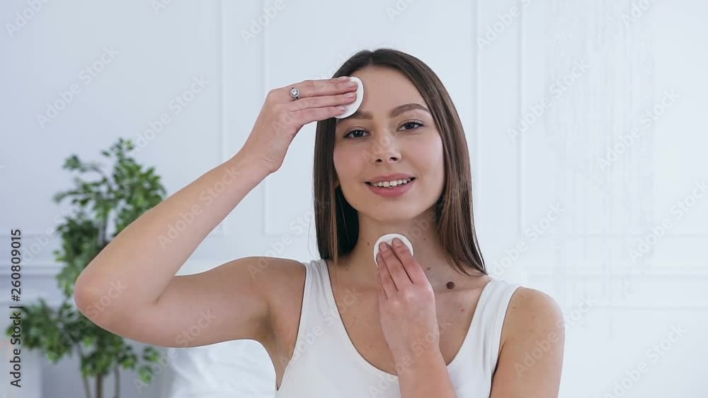 Portrait of beautiful brunette woman using cotton pads. Portrait of beautiful brunette woman using cotton pads.