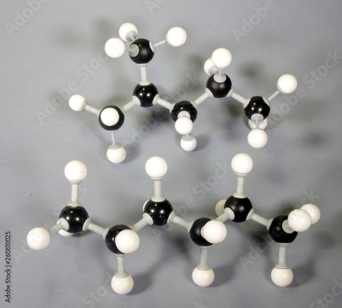 Molecule model of the isomer isohexane and hexane. Both have same amount of molecules (C6H14) but are still very different.