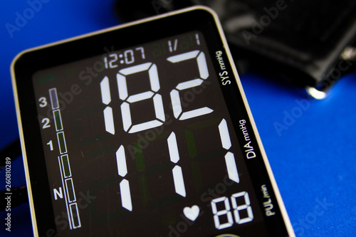 Close up of digital monitor gauge with cuff showing high diastolic and systolic blood pressure