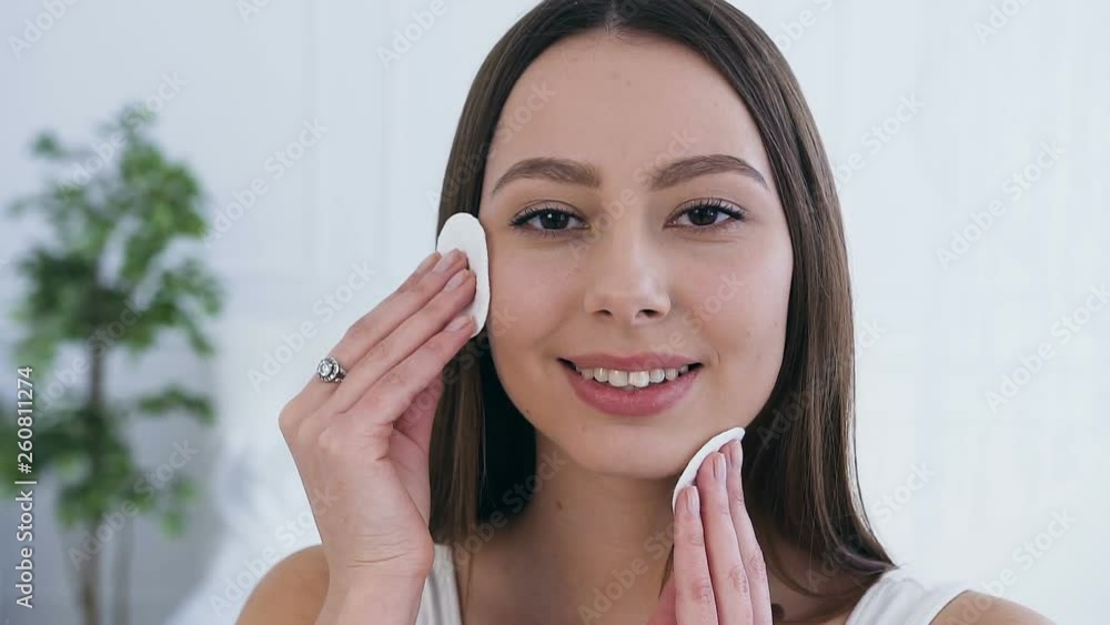 Close up shot of attractive young woman using cotton pads. Close up shot of attractive young woman using cotton pads.