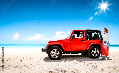 Red summer car on beach and two lovers. Two people and summer background of beach.  © magdal3na