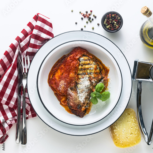 Φωτογραφία Italian melanzane alla parmigiana dish, made of eggplants and tomatoes on a table, served in a plate