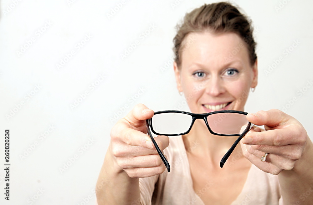 woman holding glasses on display with white background stock photo woman holding glasses on display with white background stock photo