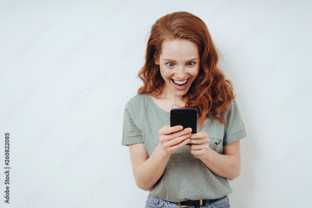 Gleeful young woman receiving good news Gleeful young woman receiving good news