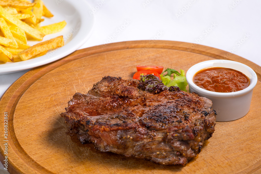 fried steak and serving with vegetables on a cutting board fried steak and serving with vegetables on a cutting board
