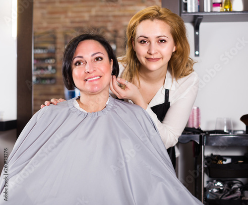 Adult woman likes very much her hairdress