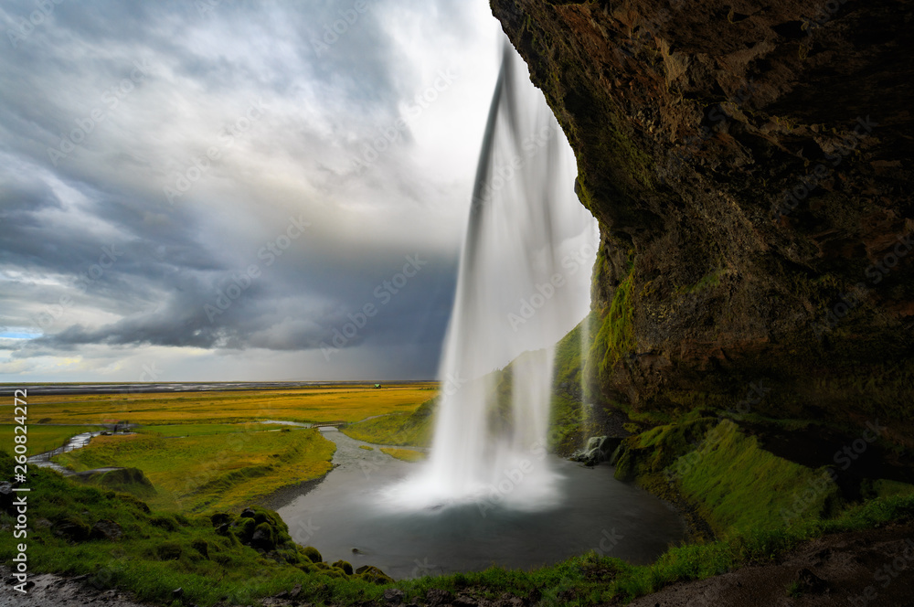 View from behind the Seljalandsfoss waterfall in Iceland.